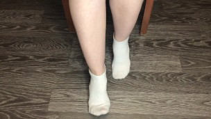 STUDENT GIRL SHOWS WHITE SOCKS AND FEET AFTER STUDYING.
